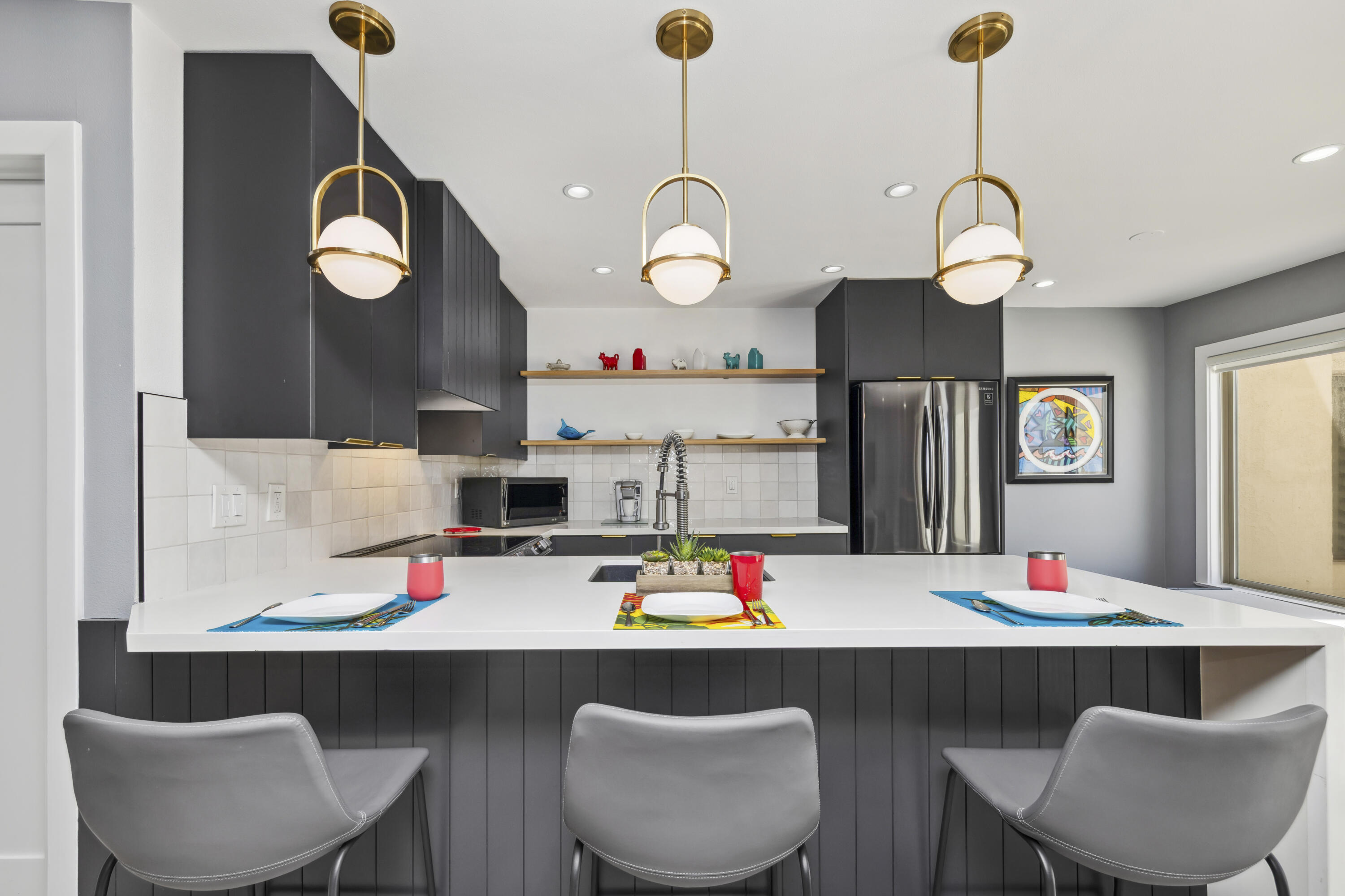 711 Pacific Coast Highway, Unit 206 Huntington Beach, CA 92648 - Photo 11 of 32 a kitchen with dining table and chairs