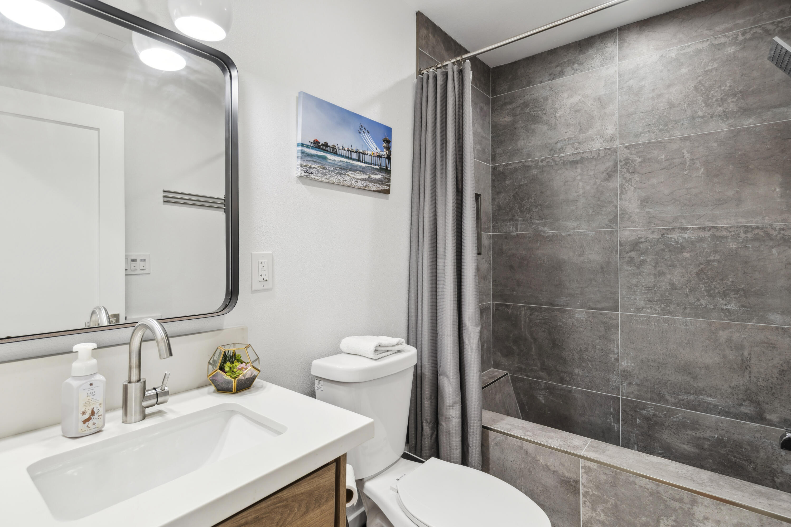 711 Pacific Coast Highway, Unit 206 Huntington Beach, CA 92648 - Photo 14 of 32 a bathroom with a sink a toilet and shower