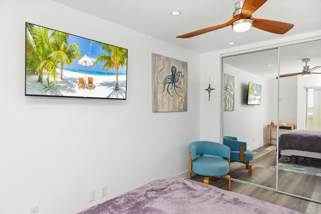 a living room with furniture and a painting on the wall