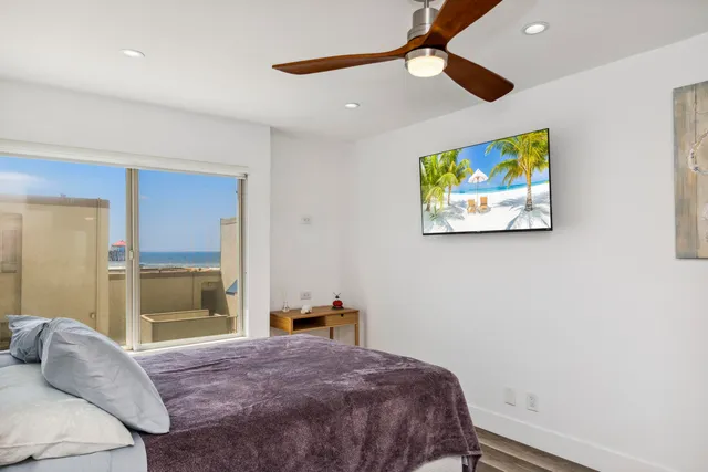 a bedroom with a bed and a painting on the wall