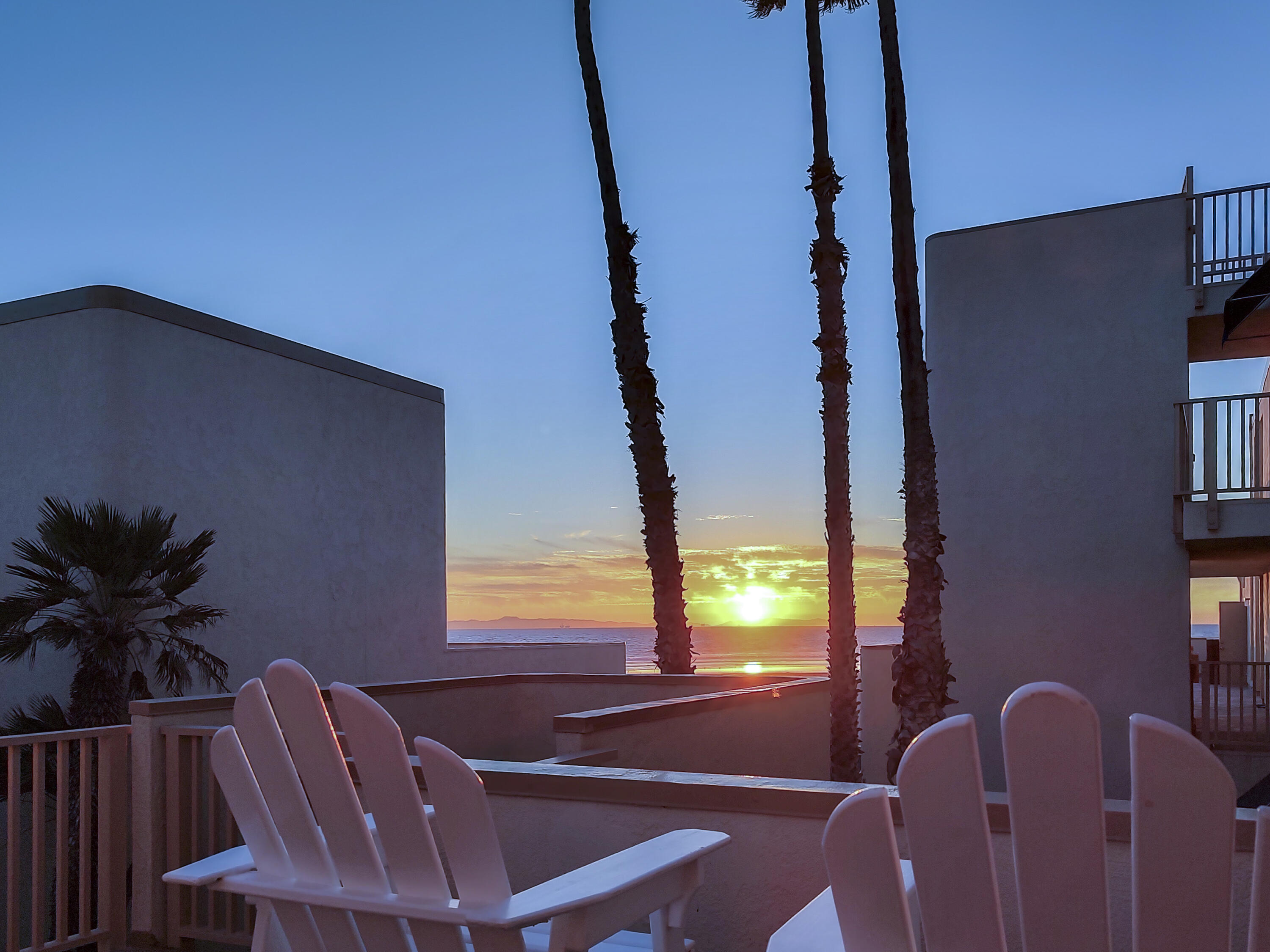 711 Pacific Coast Highway, Unit 206 Huntington Beach, CA 92648 - Photo 2 of 32 a view of balcony with two chairs and a potted plant