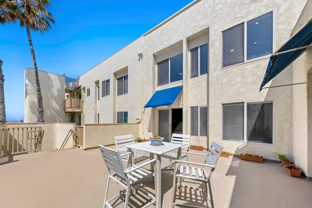 a view of a patio with a table and chairs