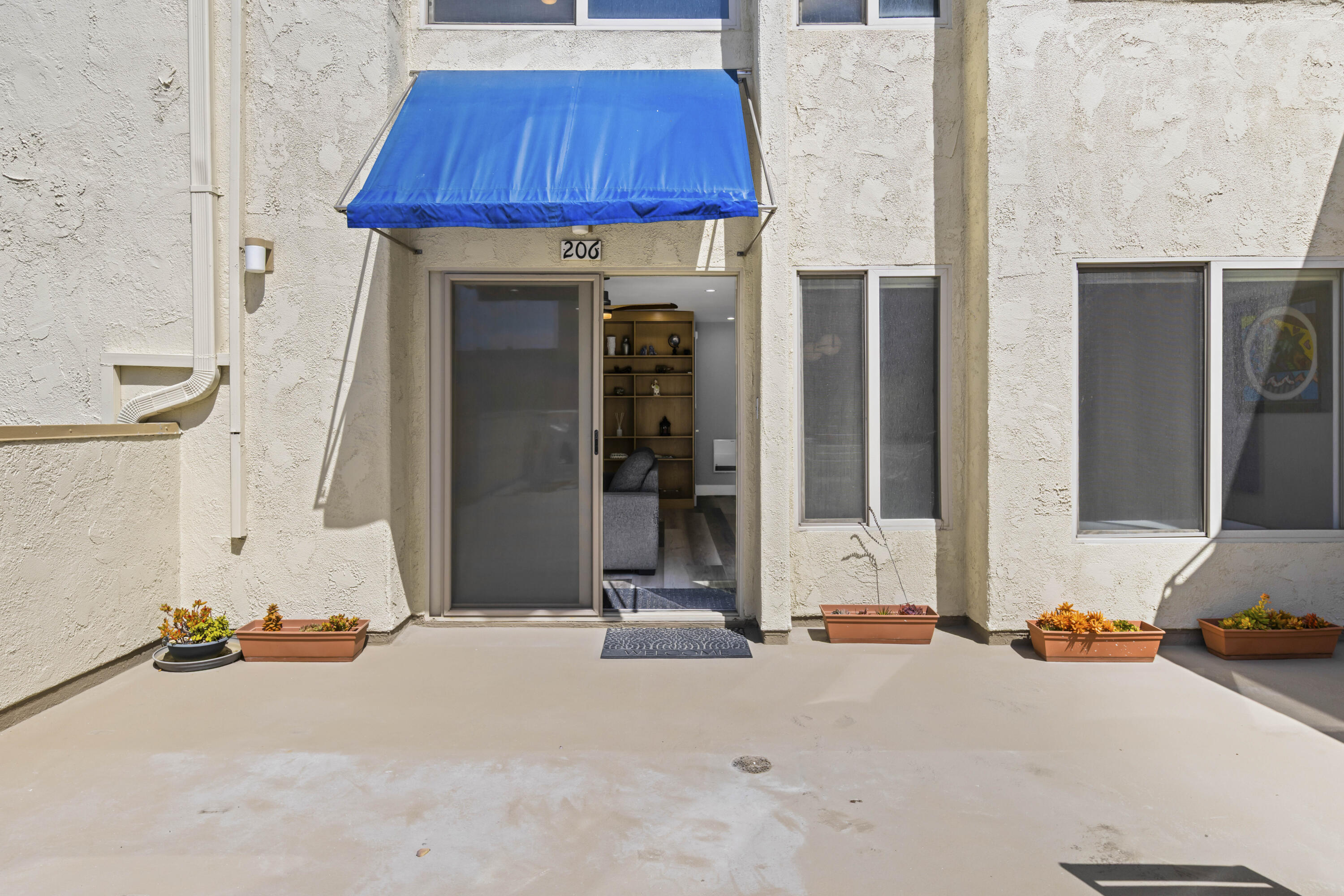 711 Pacific Coast Highway, Unit 206 Huntington Beach, CA 92648 - Photo 4 of 32 an outdoor view of house with garage