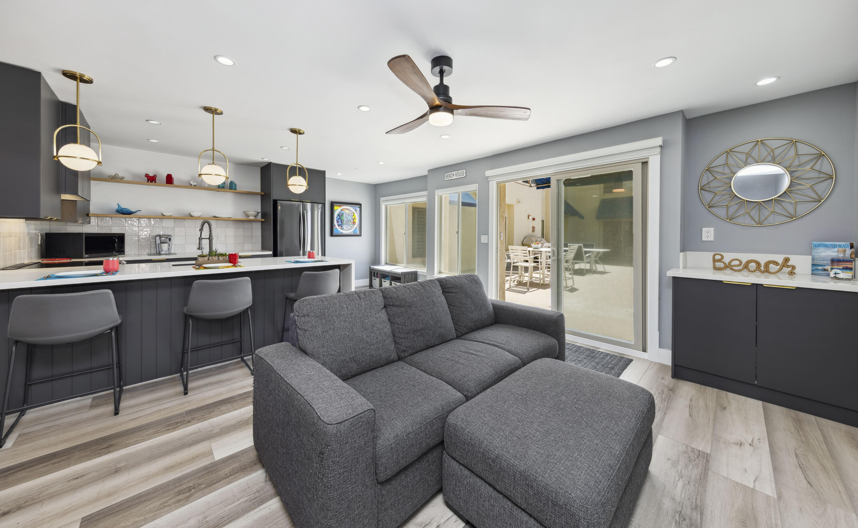 711 Pacific Coast Highway, Unit 206 Huntington Beach, CA 92648 - Photo 6 of 32 a living room with furniture kitchen view and a chandelier