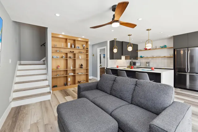 a living room with furniture and kitchen view