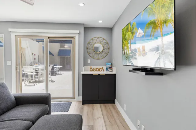 a living room with a bed and a refrigerator