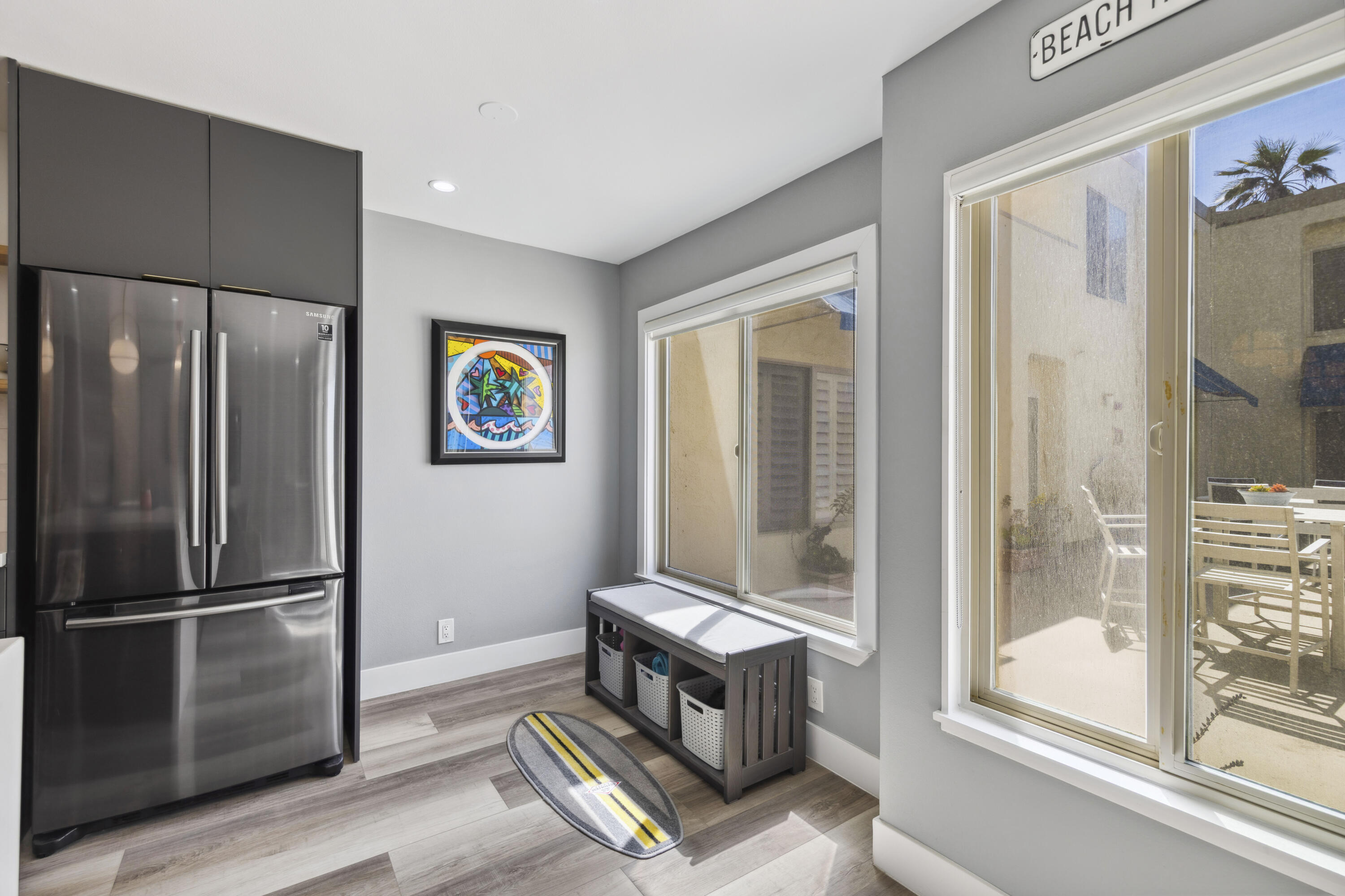 711 Pacific Coast Highway, Unit 206 Huntington Beach, CA 92648 - Photo 9 of 32 a living room with a bed and a refrigerator