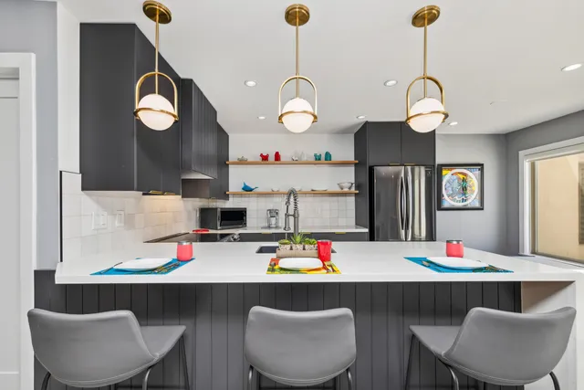 a kitchen that has a stove and a table