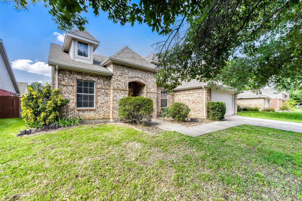 2617 Hereford Road Denton, TX 76210 - Photo 2 of 27 a front view of a house with a yard and garage