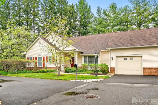 a view of a house next to a yard and road