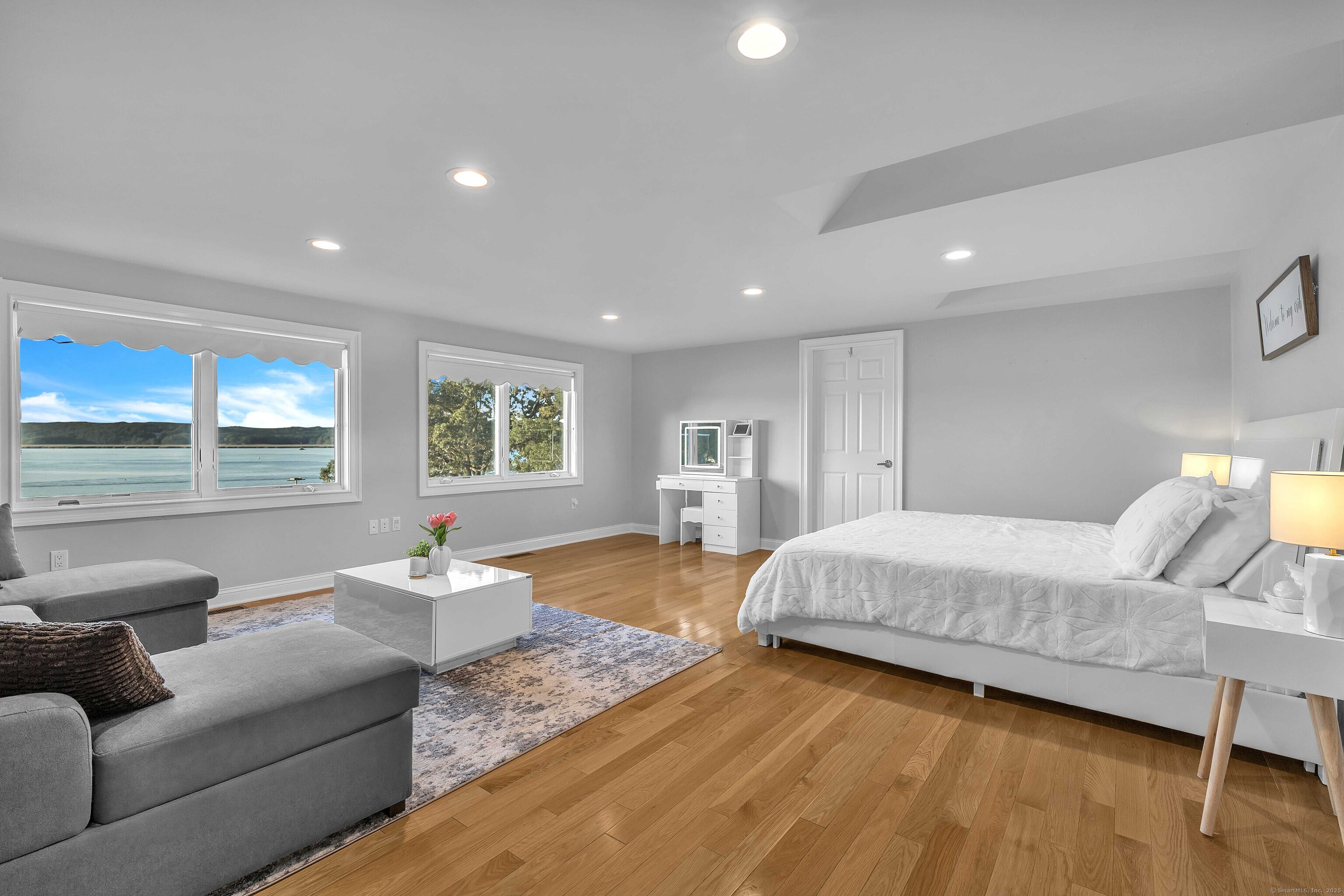 12 Rocky Point Road Old Saybrook, CT 06475 - Photo 16 of 28 a spacious bedroom with a bed couch and wooden floor