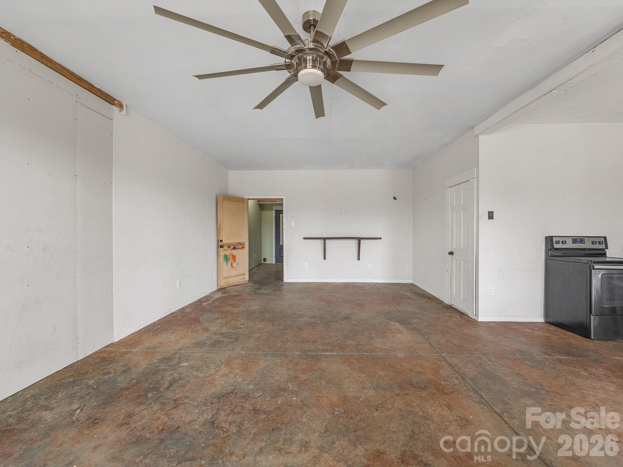 1487 Hayes Road Columbus, NC 28722 - Photo 28 of 48 a view of a room with a ceiling fan and refrigerator