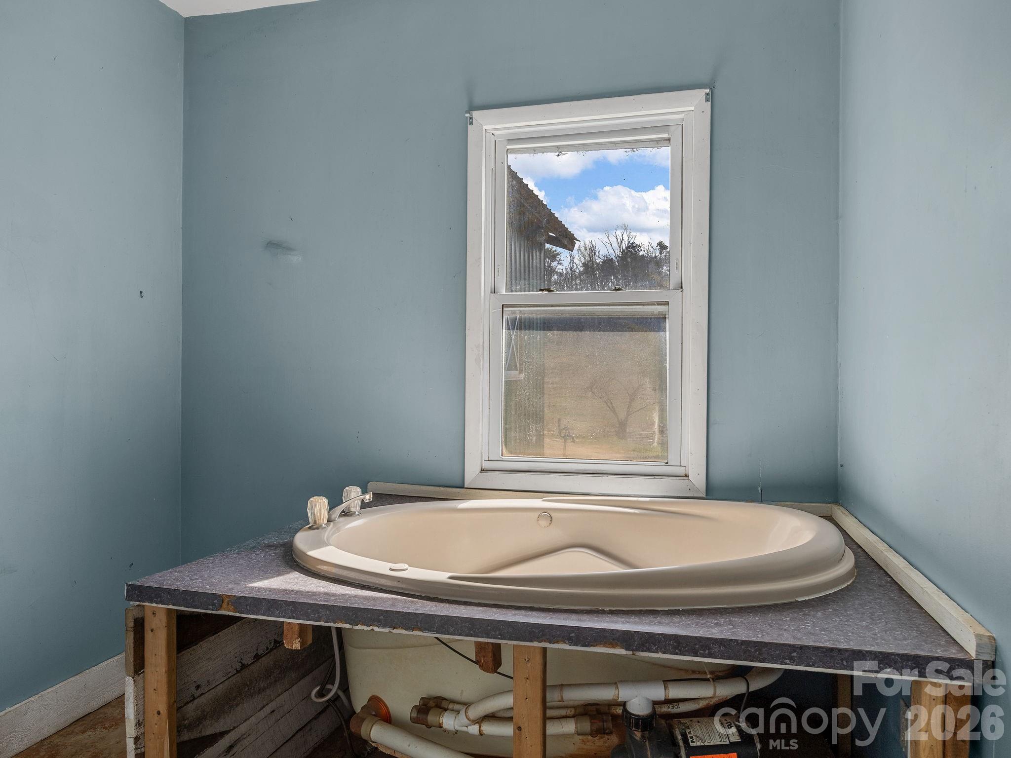 1487 Hayes Road Columbus, NC 28722 - Photo 29 of 48 a bathroom with a granite countertop sink and a toilet