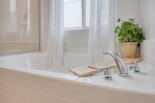 a view of a balcony with wooden floor and fence