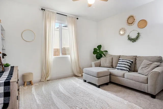 a view of a patio with table and chairs potted plants with floor to ceiling windows