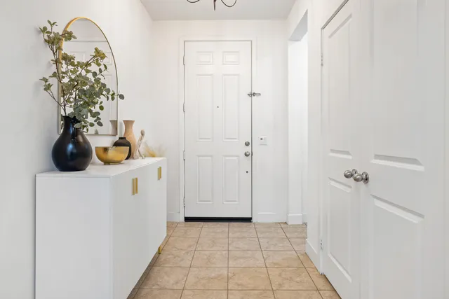 a kitchen with kitchen island granite countertop a sink a counter cabinets and living room view