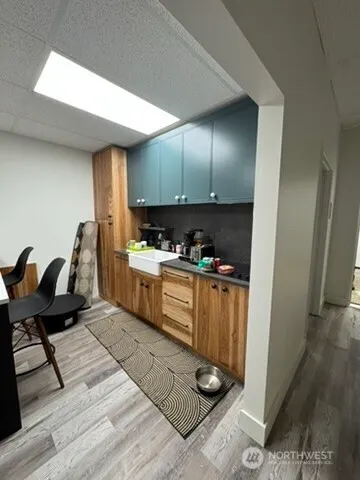 a kitchen with granite countertop a stove a sink and a refrigerator