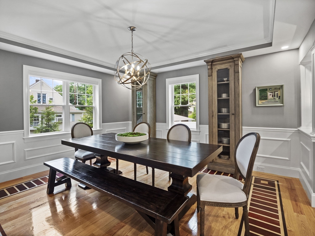 3 Mooney Road Burlington, MA 01803 - Photo 5 of 34 a dining room with wooden floor a chandelier a wooden table and chairs