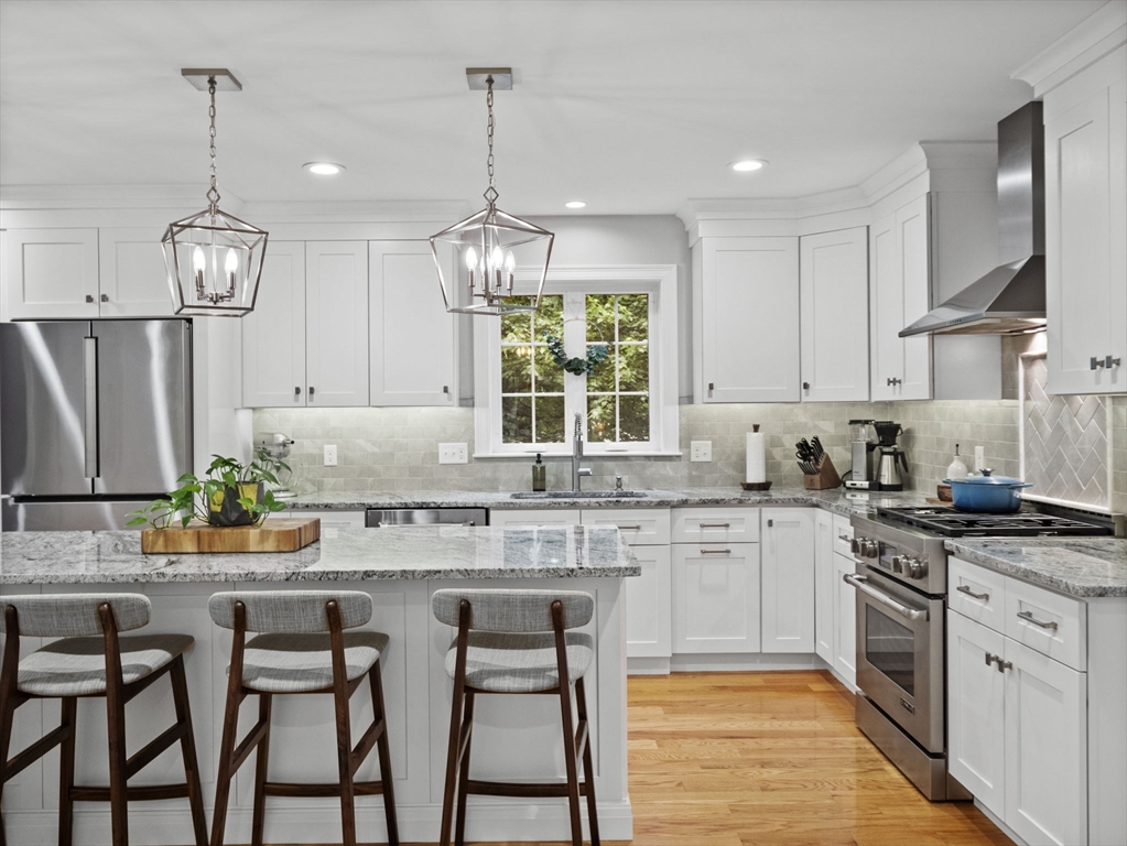 3 Mooney Road Burlington, MA 01803 - Photo 8 of 34 a kitchen with stainless steel appliances granite countertop a stove top oven a refrigerator a sink and dishwasher a oven with wooden floor
