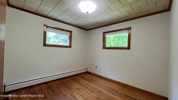 a view of empty room with wooden floor