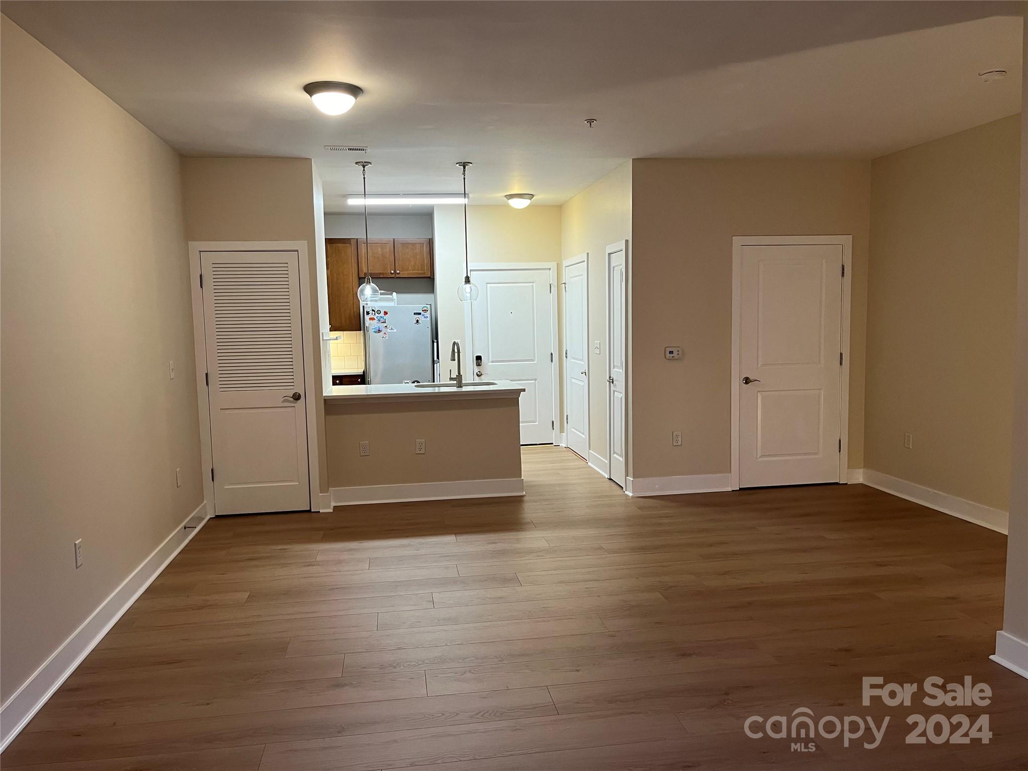 a view of a kitchen cabinets and wooden floor