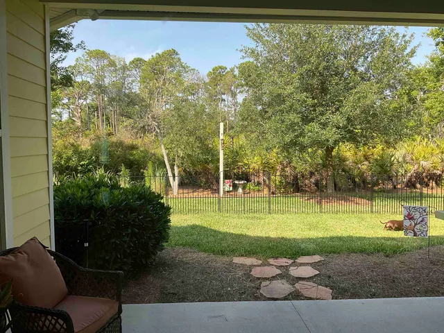 a view of a kitchen with kitchen island granite countertop a sink counter top space appliances and cabinets
