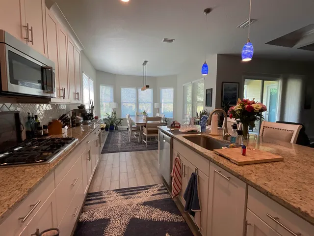 a front view of a house with a yard and trees