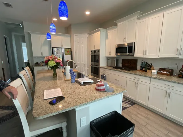 a kitchen with sink a microwave and cabinets