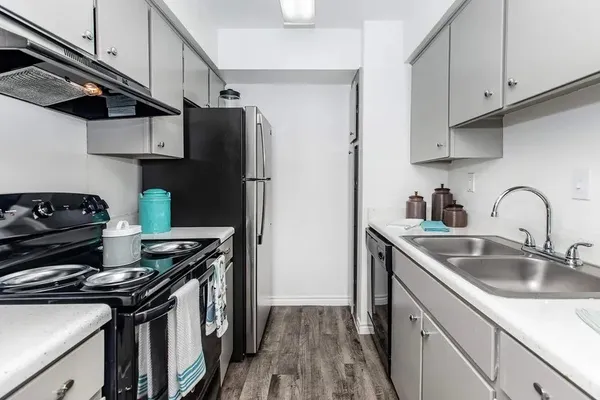 a bathroom with a granite countertop sink a toilet and a mirror