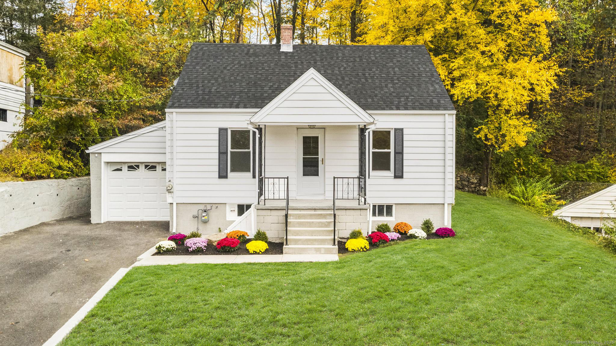 a view of a house with a backyard and garden