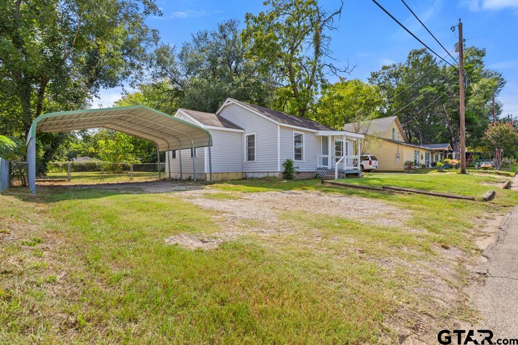 210 Cooper Street Lindale, TX 75771 - Photo 22 of 23 a view of a house with a yard and large trees