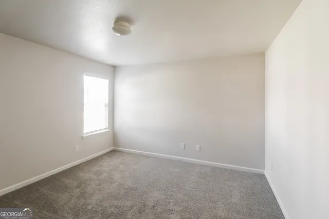 an empty room with a empty space and windows