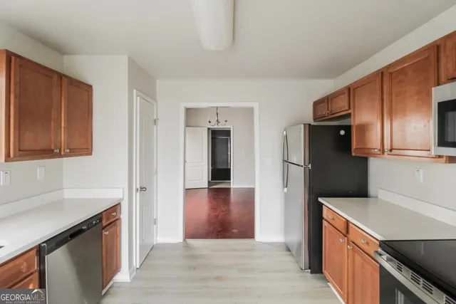 a kitchen with stainless steel appliances granite countertop a sink stove and cabinets