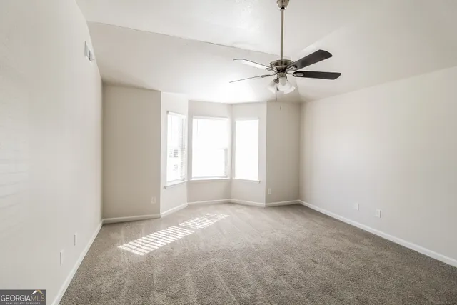 a view of a big room with chandelier fan