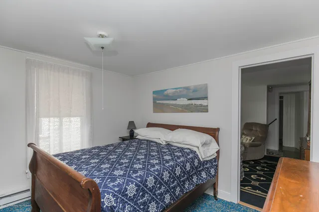 a bedroom with bed and window