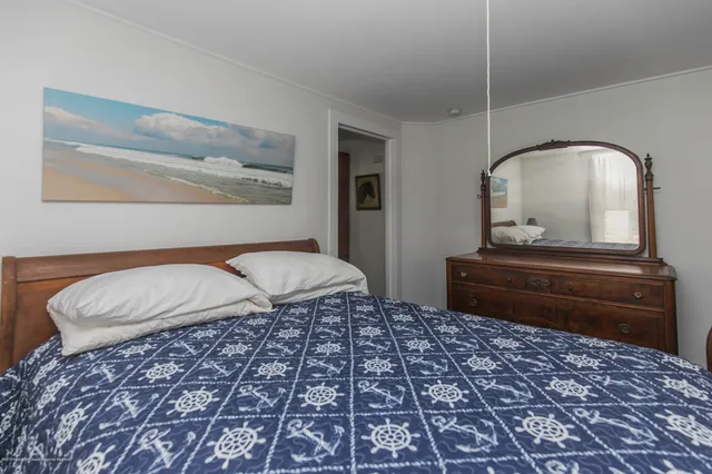 a bedroom with a bed and a dresser