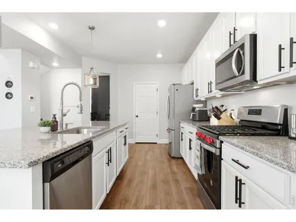 a kitchen with stainless steel appliances granite countertop a stove and a sink