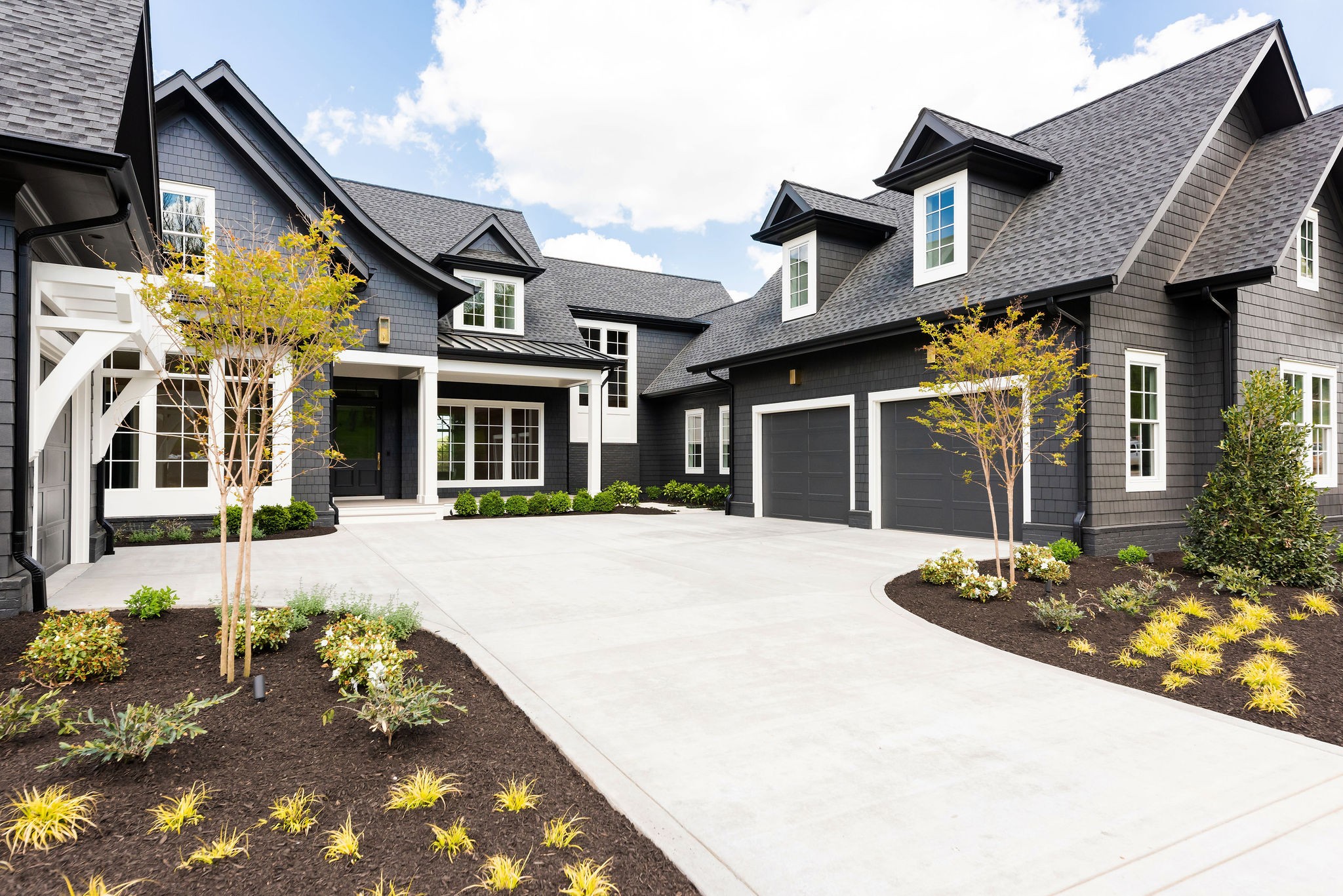 8182 Heirloom Boulevard College Grove, TN 37046 - Photo 2 of 34 a front view of a house with a garden