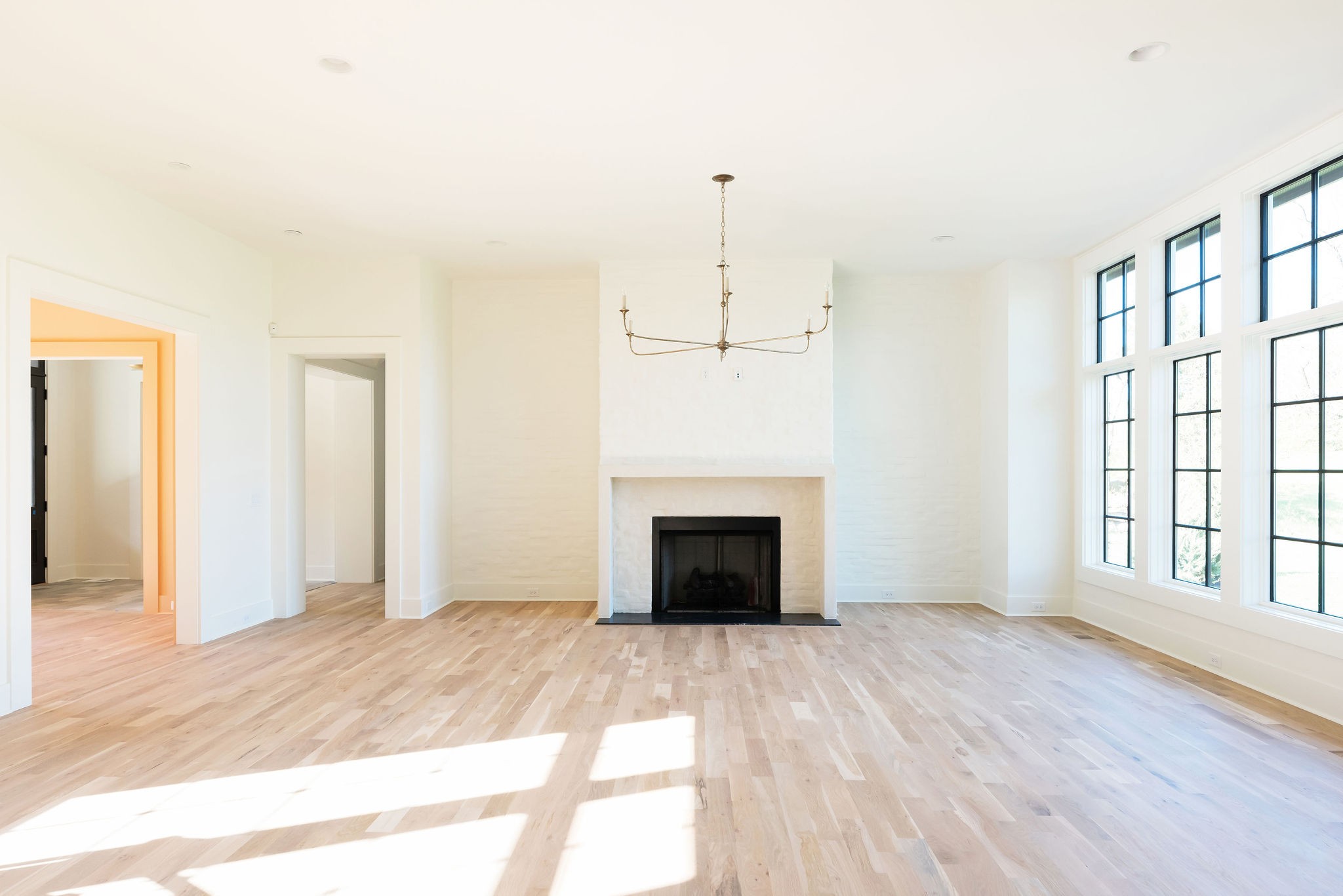 8182 Heirloom Boulevard College Grove, TN 37046 - Photo 5 of 34 a view of an empty room with wooden floor fireplace and a window