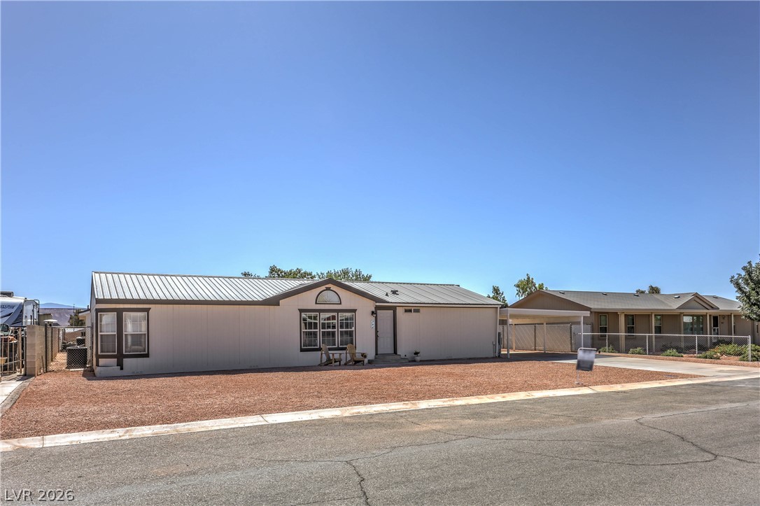 348 Tres Palomas Street Overton, NV 89040 - Photo 4 of 41 A well-maintained single-story residence with a durable metal roof, offering both style and practicality.