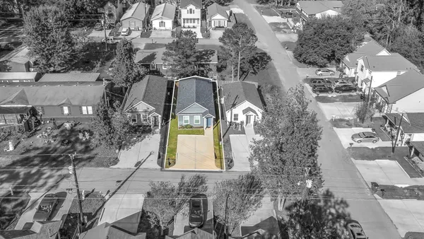 an aerial view of a house with a yard