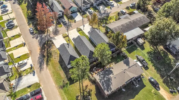 an aerial view of a residential apartment building with a yard