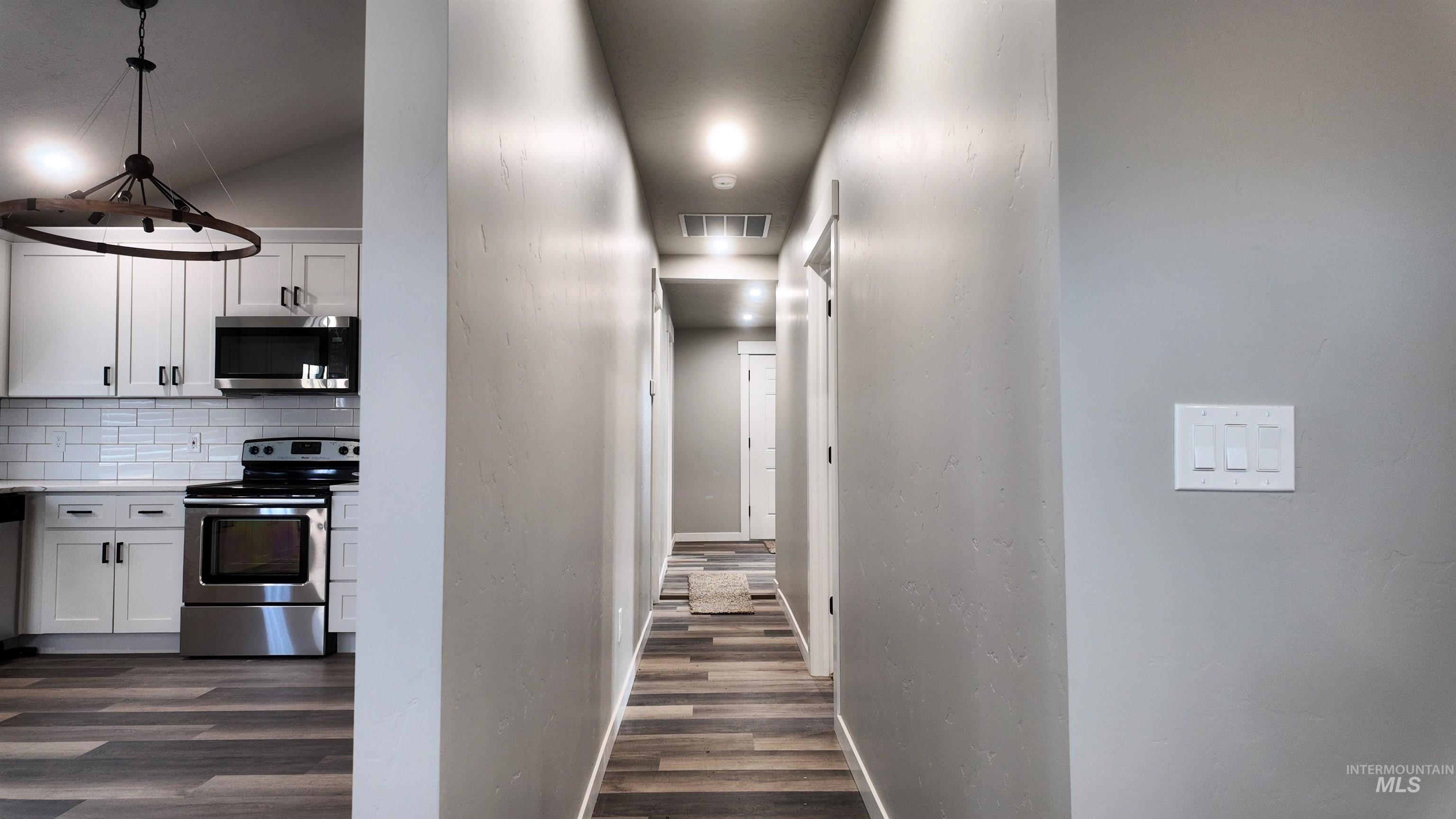 5850 Lockett Road Huntington, OR 97907 - Photo 22 of 49 Hall featuring dark wood-style floors and a textured wall