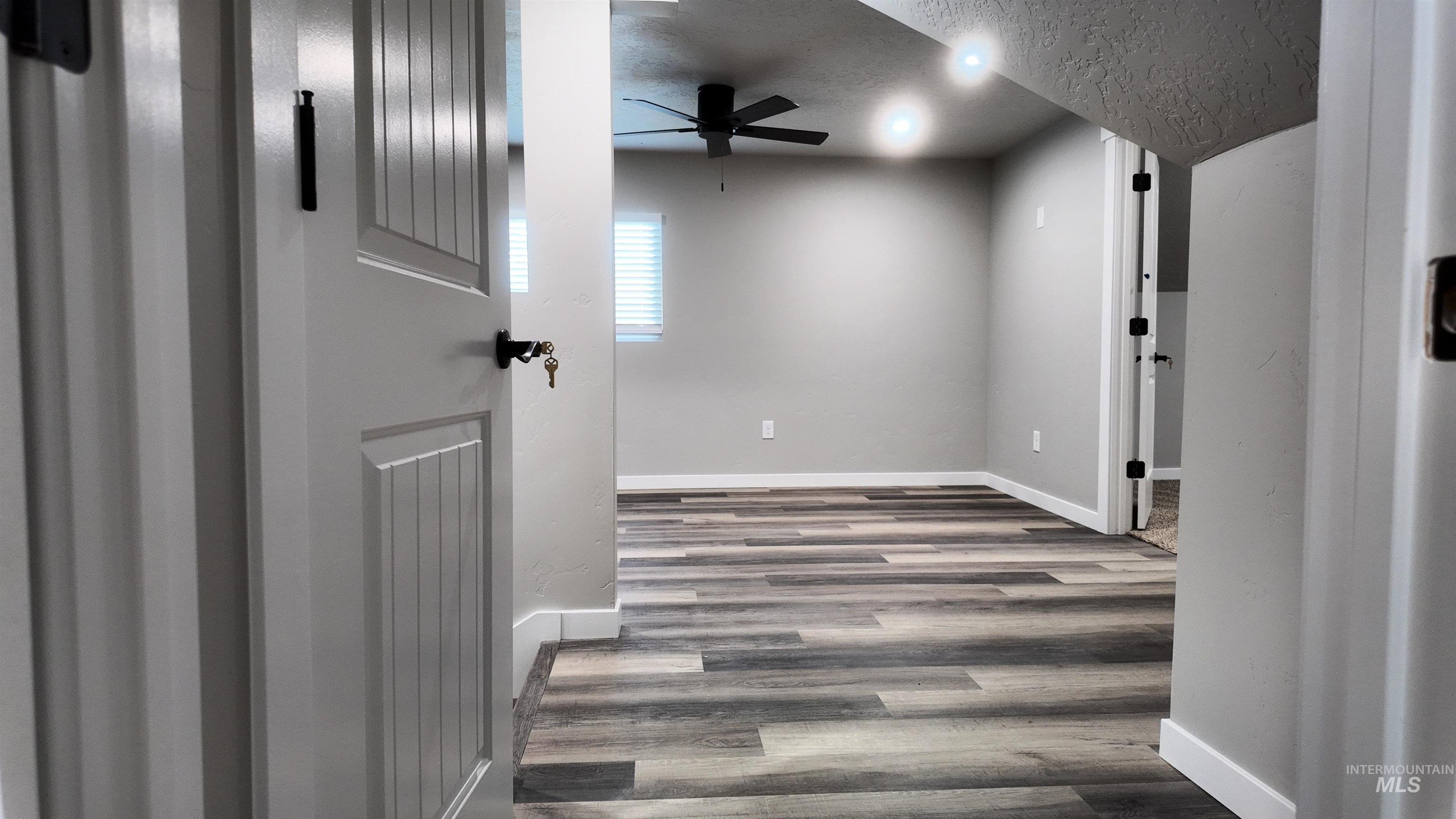 5850 Lockett Road Huntington, OR 97907 - Photo 39 of 49 Hallway featuring a textured ceiling and wood finished floors