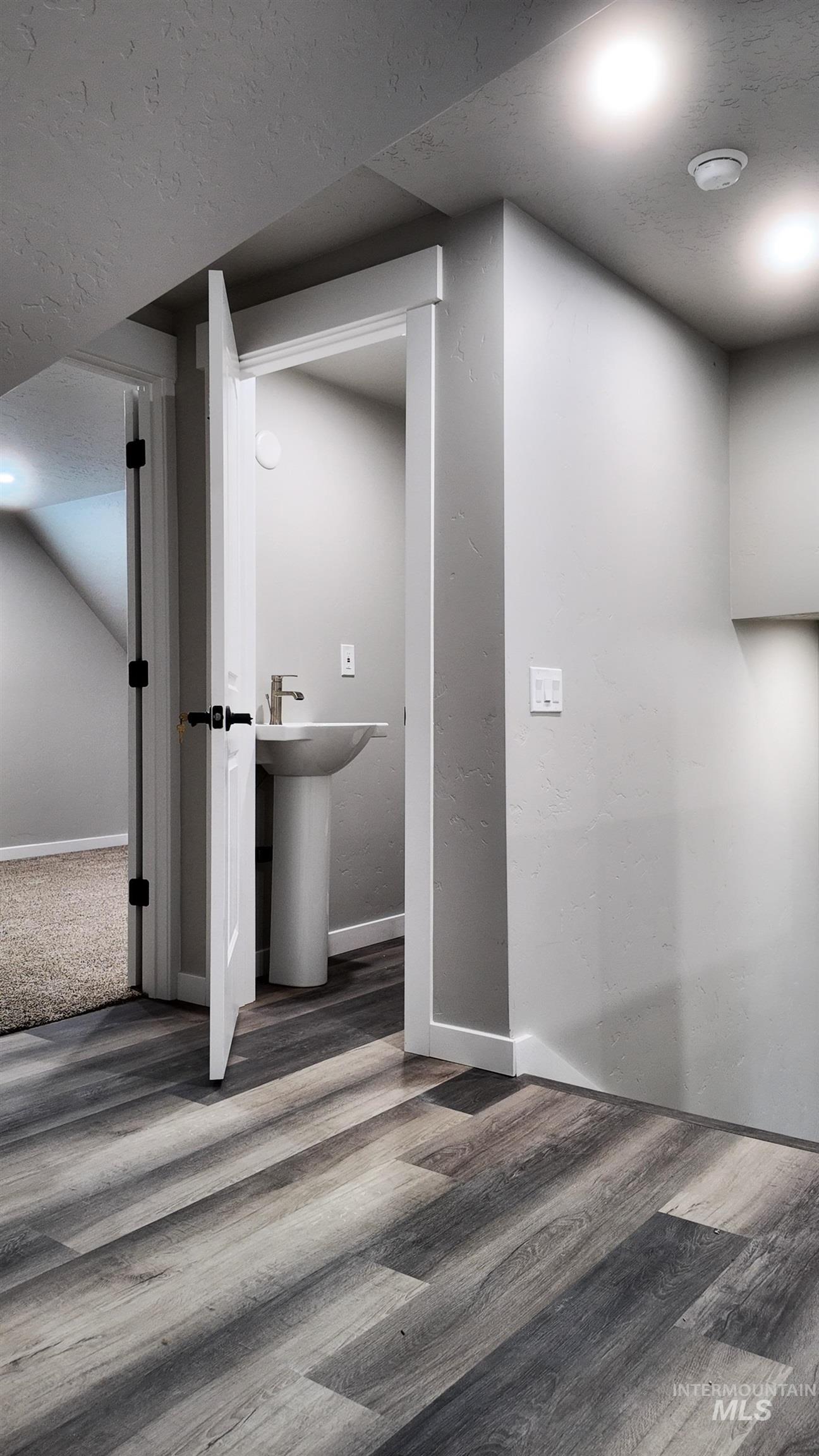 5850 Lockett Road Huntington, OR 97907 - Photo 45 of 49 Below grade area featuring wood finished floors and a textured ceiling