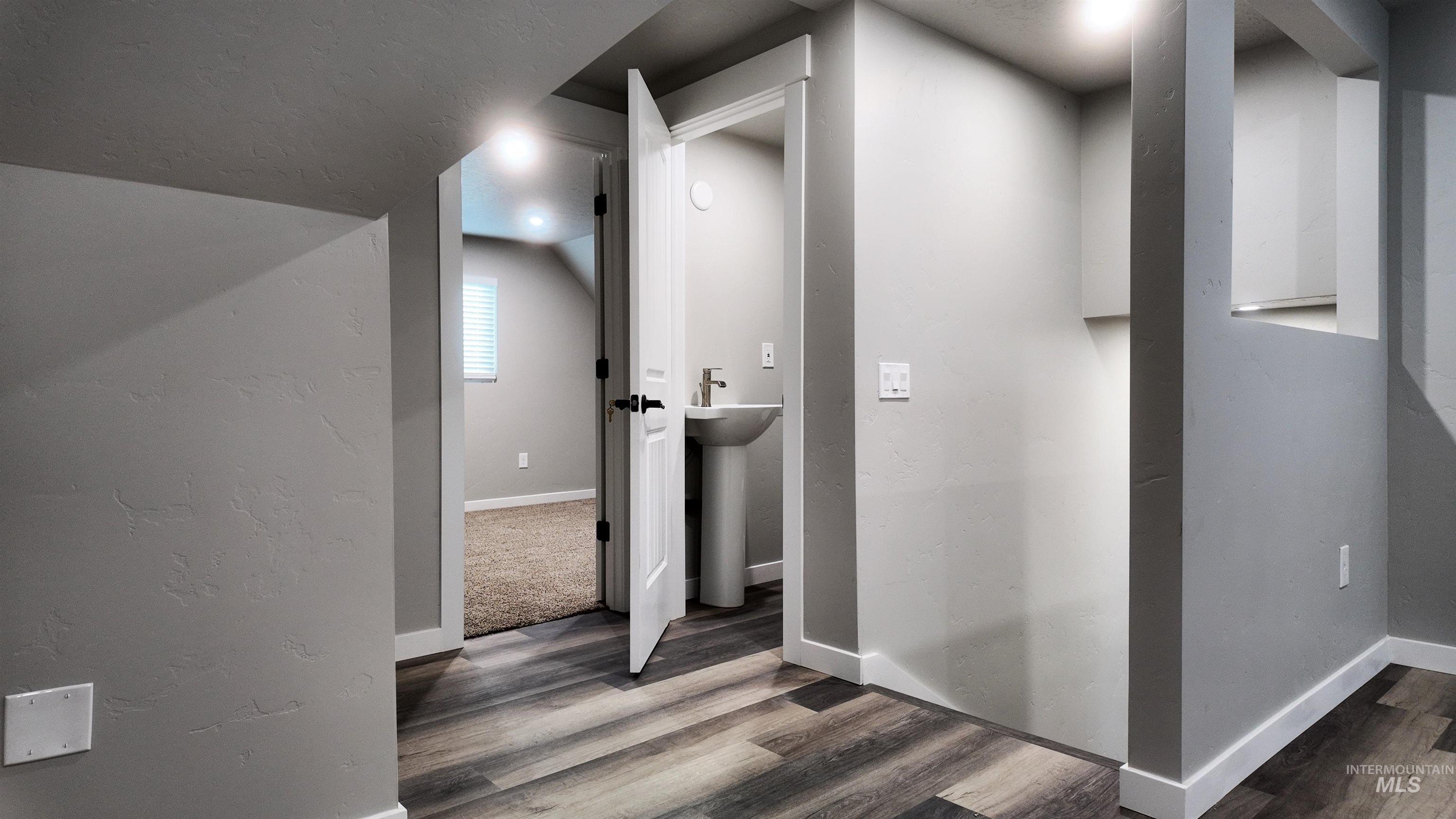 5850 Lockett Road Huntington, OR 97907 - Photo 46 of 49 Hallway with wood finished floors and a textured wall