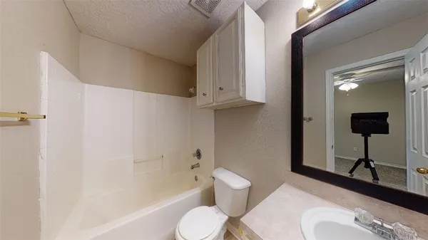a bathroom with a toilet a sink and bathtub