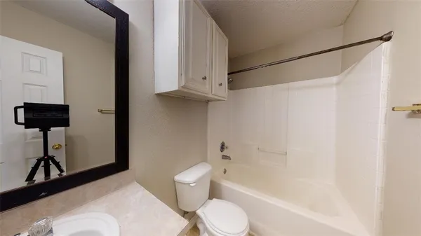 a bathroom with a toilet tub and a shower
