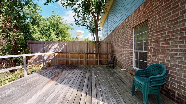 a view of balcony with wooden floor and outdoor seating