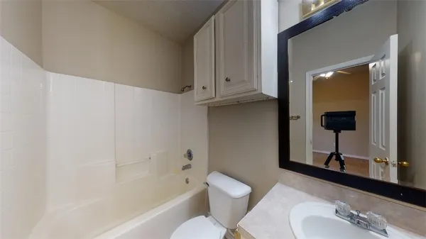 a bathroom with a toilet and a tub